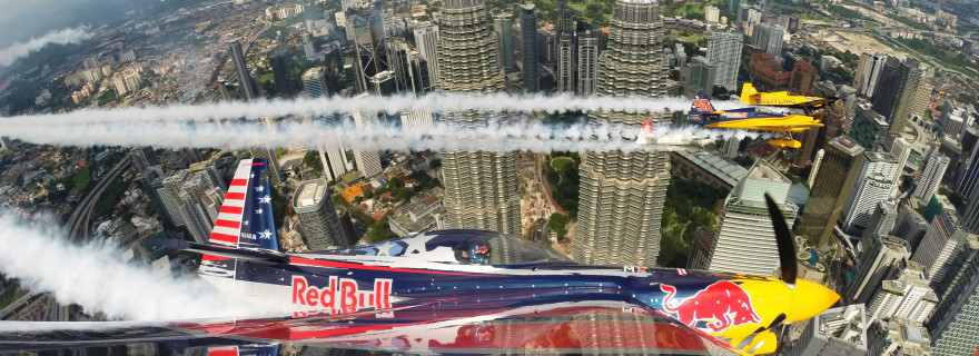 Kirby Chambliss of the United States flies in formation with Matt Hall of Australia, Yoshihide Muroya of Japan and Nigel Lamb of Great Britain prior to the third stage of the Red Bull Air Race World Championship in front of the Petronas Towers in Kuala Lumpur, Malaysia on May 15, 2014.