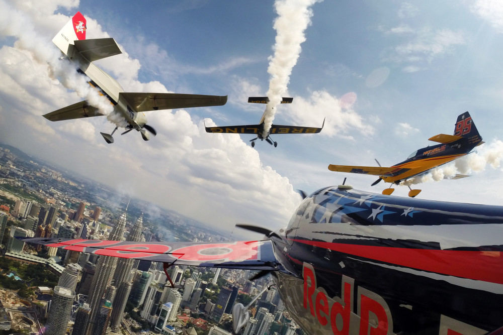 Kirby Chambliss of the United States flies in formation with Matt Hall of Australia, Yoshihide Muroya of Japan and Nigel Lamb of Great Britain