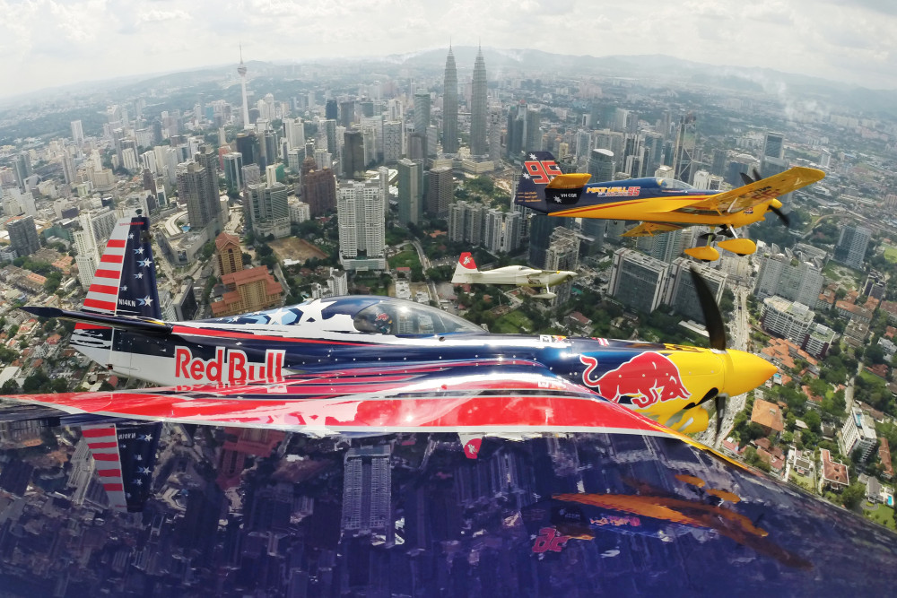 Kirby Chambliss of the United States flies in formation with Matt Hall of Australia, Yoshihide Muroya of Japan and Nigel Lamb of Great Britain